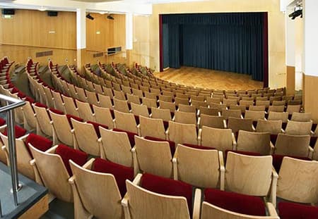 the conference room, several rows of seats in a theatre-like setup